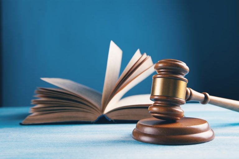 A judge's gavel resting on an open book